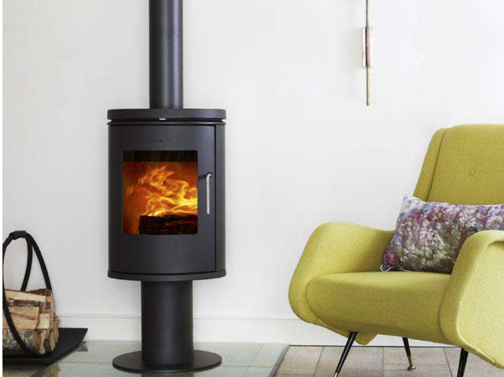 Screenshot_20-1-2025_11913_wwwstovesupermarketcouk | Everpro Ltd a styling wood burning stove cozily alight nect to a pile of logs. To the left is a green armchair